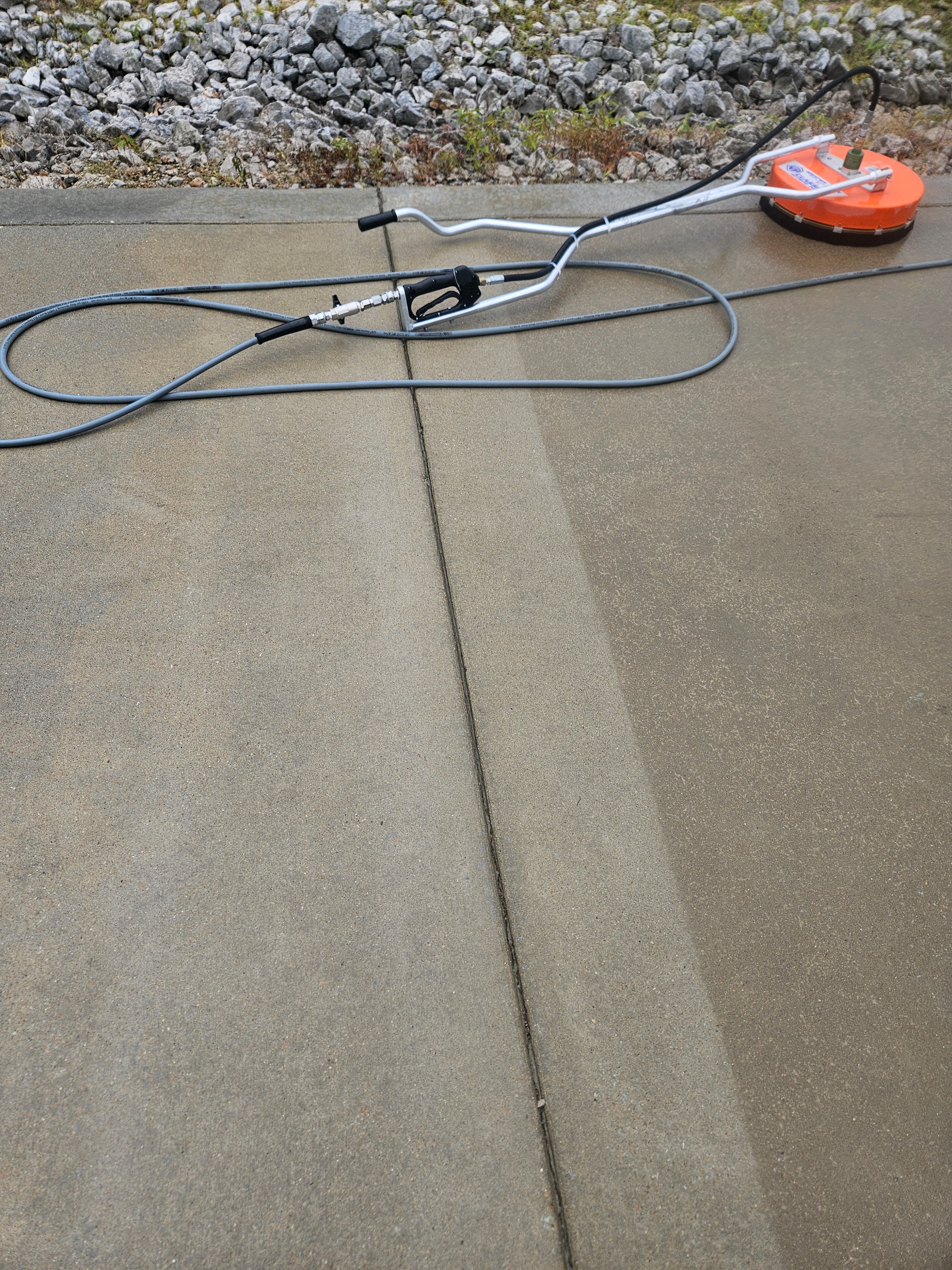 Surface cleaner on freshly pressure washed concrete driveway